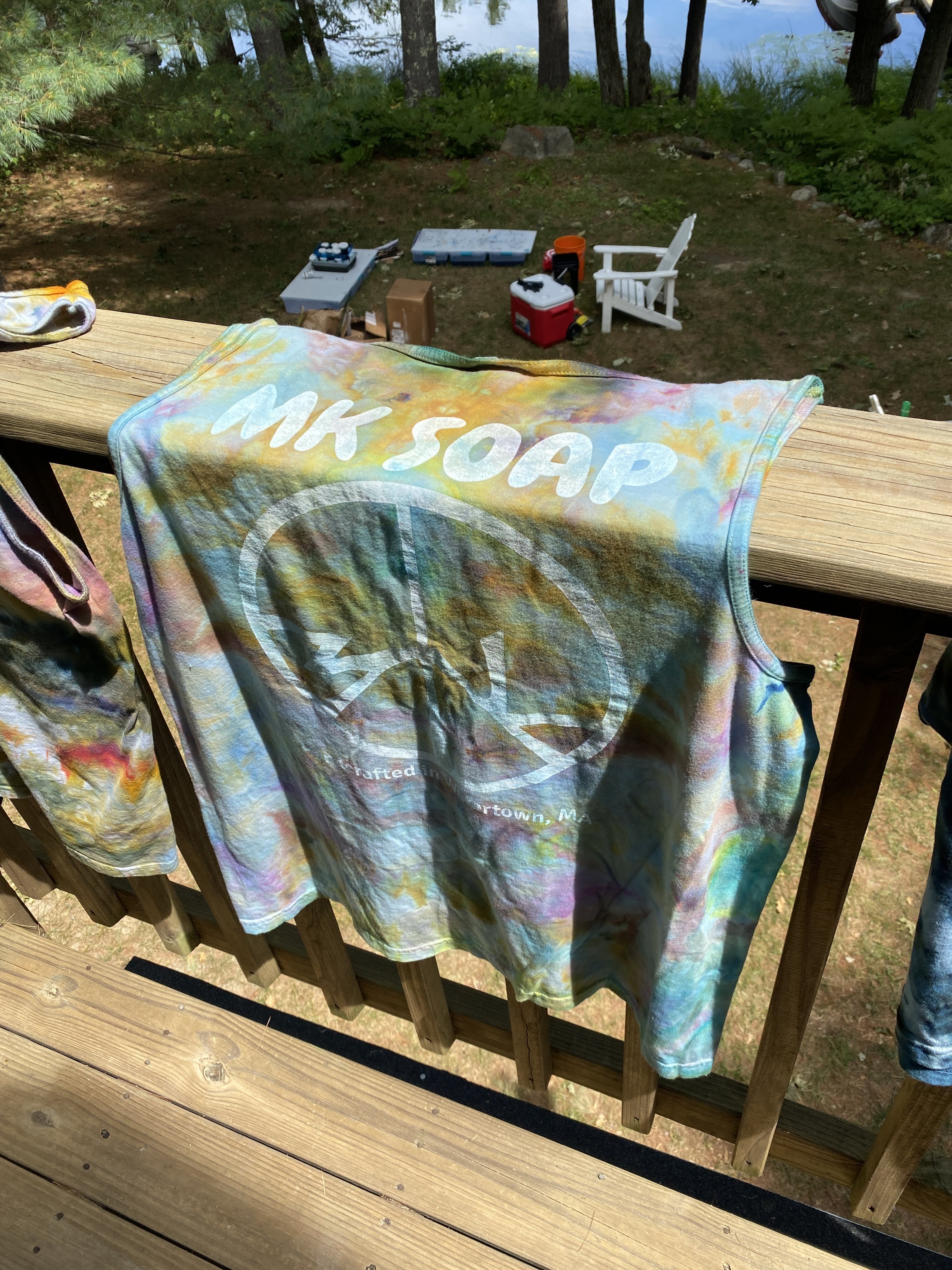 Tie-dyed MK Soap tank top hanging outdoors