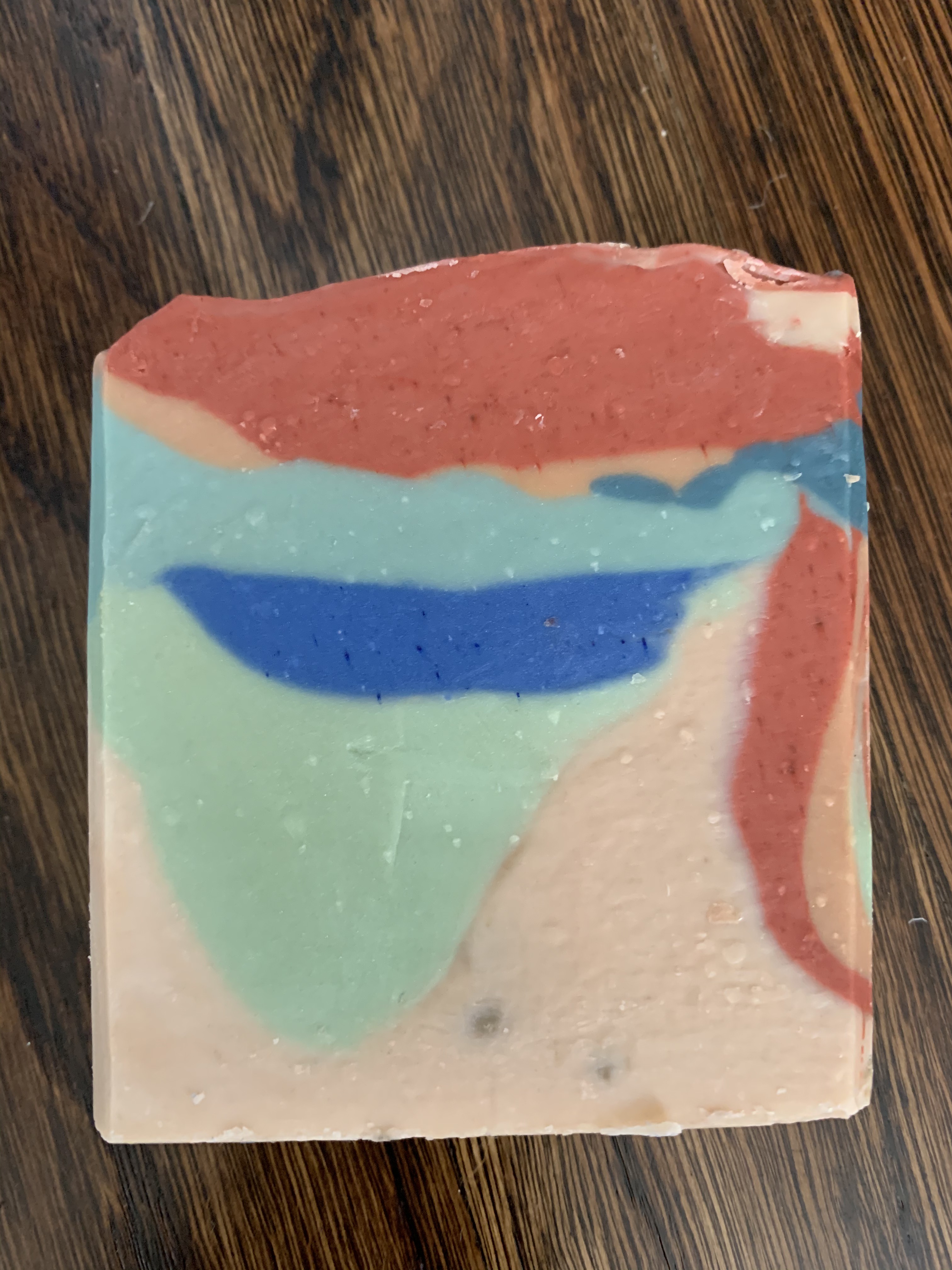 Soap bar with a peach, green and blue landscape-style design